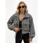 Woman wearing a black and white houndstooth cropped utility jacket