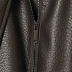 Brown faux leather jacket asymmetric zipper close-up