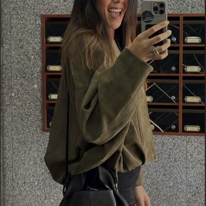 Woman wearing an army green ultra-loose faux suede bomber jacket in a mirror selfie