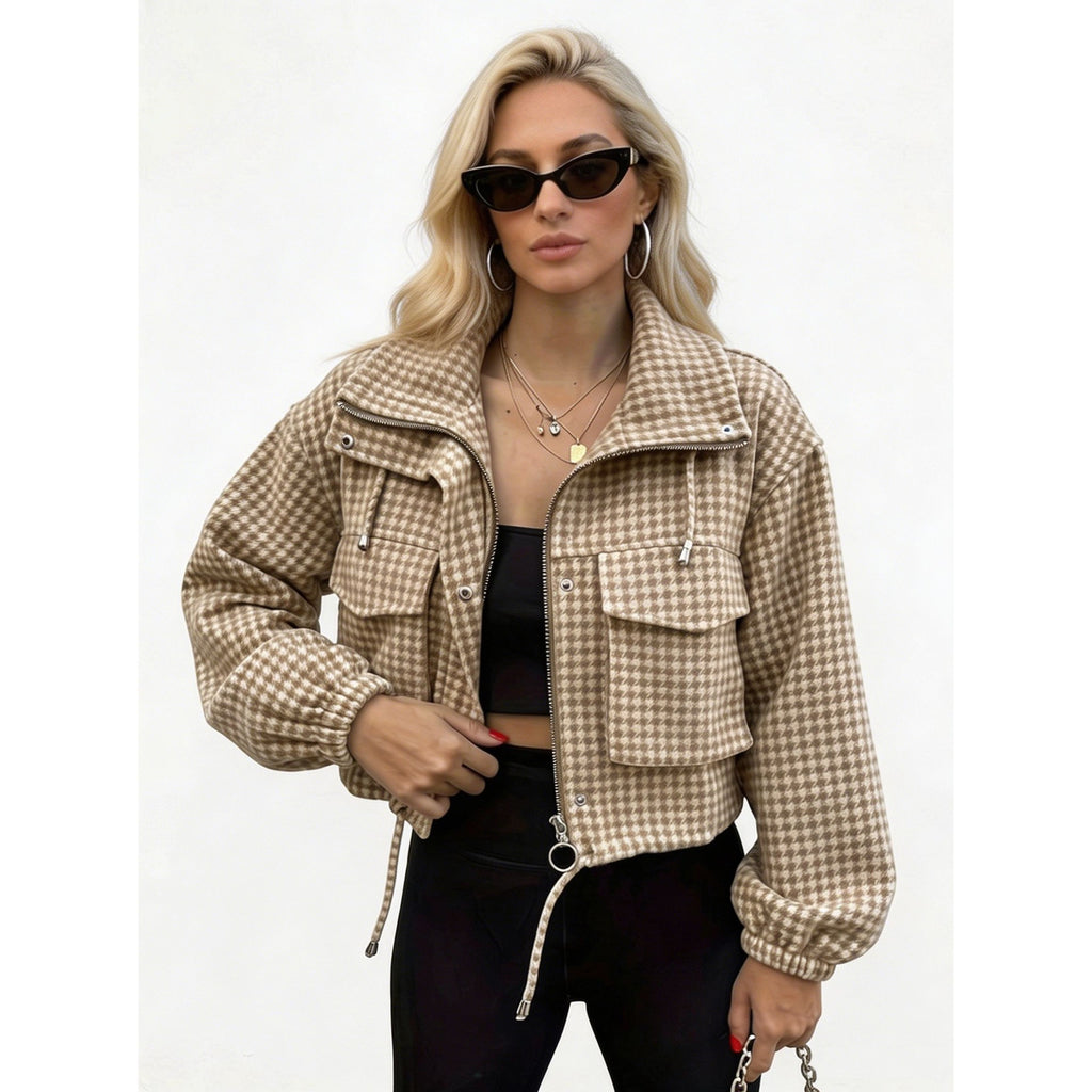 Woman wearing a light brown houndstooth cropped utility jacket