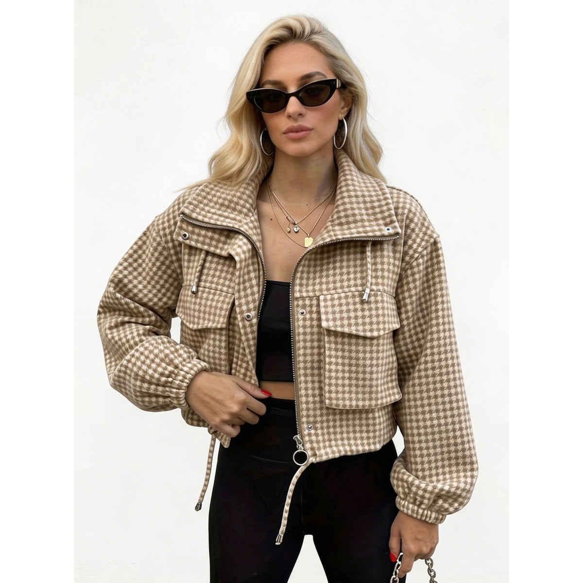 Woman wearing a light brown houndstooth cropped utility jacket
